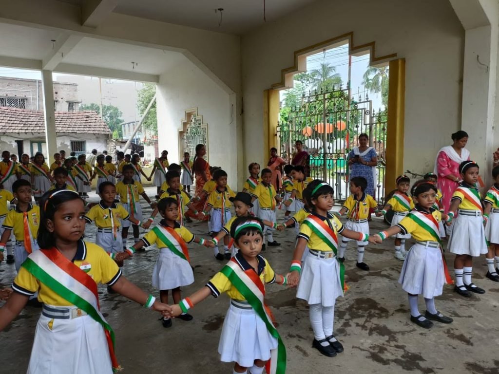 Students of Bhaskar Children Academy in uniform with tricolour sashes during the Independence Day march