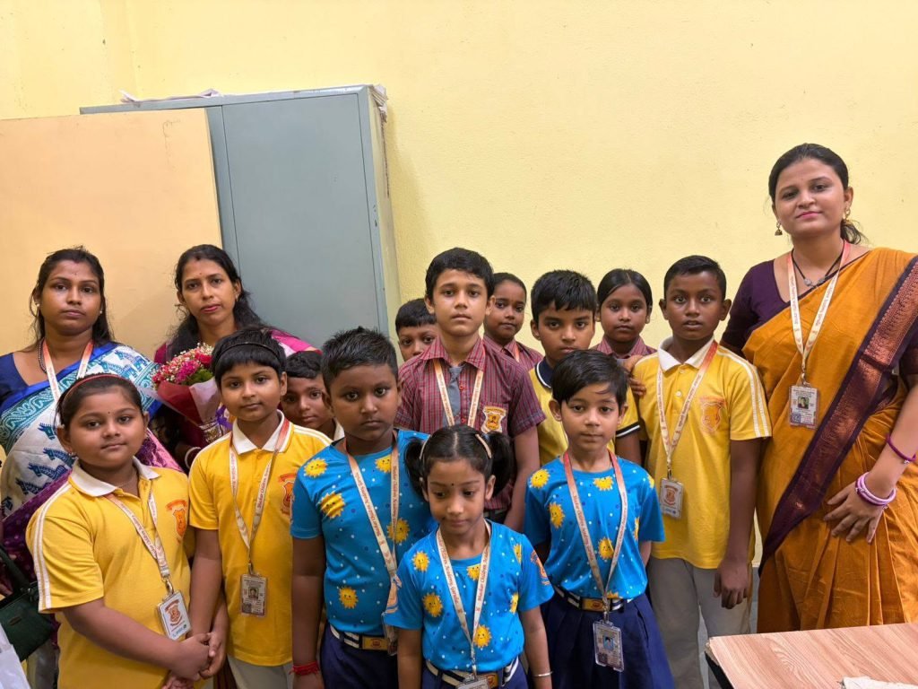 Students wearing medals with their teachers after a school prize giving