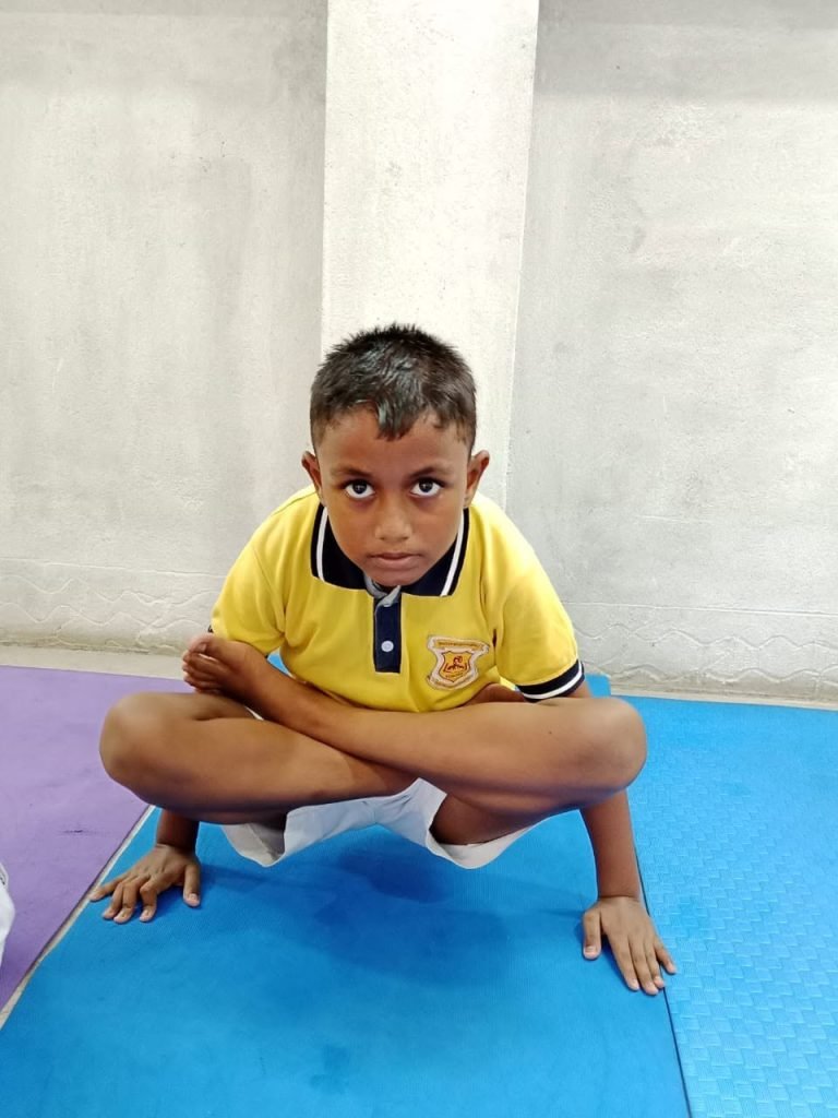 A student of Bhaskar Children Academy holding a yoga posture on International Yoga Day